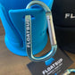 Floatsup carabiner in a light aqua color attached to a Floatsup Cup paddle board drink holder. Carabiner says "Floatsup" on it on one side and www.floatsupfun.com on the other. 